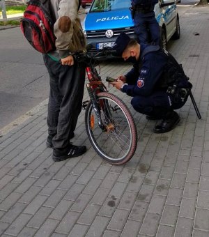 Policjant kontroluje rowerzystę